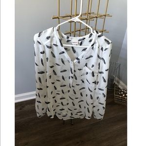 White blouse with black feather pattern.